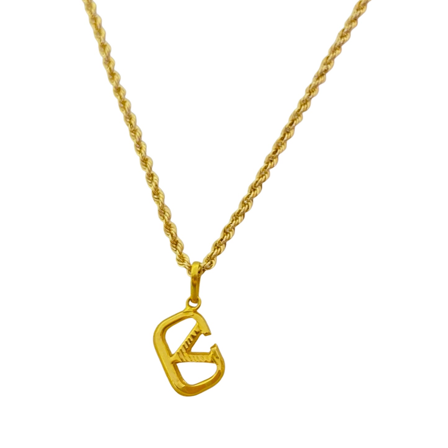 Gold necklace with a unique pendant on a white background