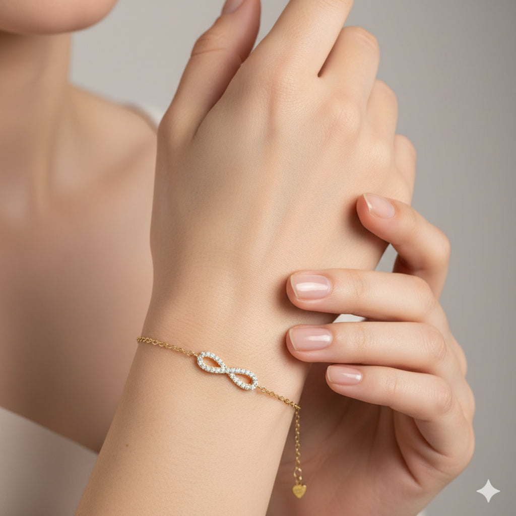 Gold bracelet with an infinity symbol on a maroon background