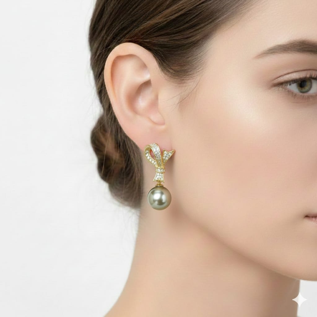 Pearl earring worn by a model on a plain background