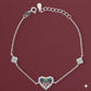 Silver bracelet with a heart-shaped clasp featuring colorful stones on a maroon background