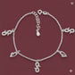 Silver bracelet with charms on a red background