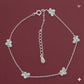 Silver bracelet with flower-shaped charms on a red background