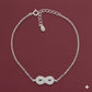 Silver bracelet with an infinity symbol on a red background