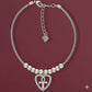 Silver bracelet with heart-shaped Ankh charm on a red background