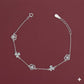 Silver bracelet with floral designs on a maroon background