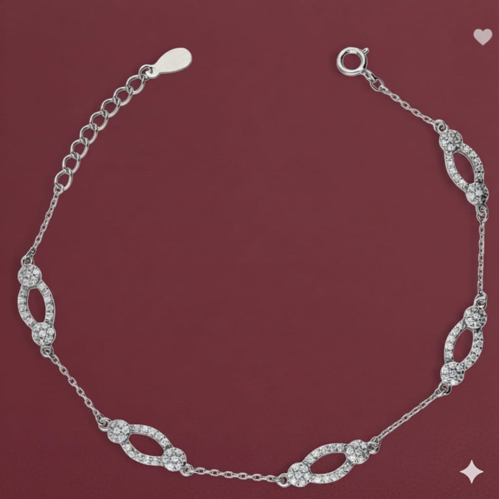Silver bracelet with diamond-like stones on a maroon background