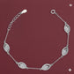 Silver bracelet with diamond-like stones on a maroon background