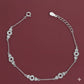Silver bracelet with floral designs on a maroon background