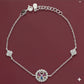 Silver bracelet with a decorative clasp on a maroon background