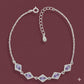 Silver bracelet with purple gemstones on a maroon background