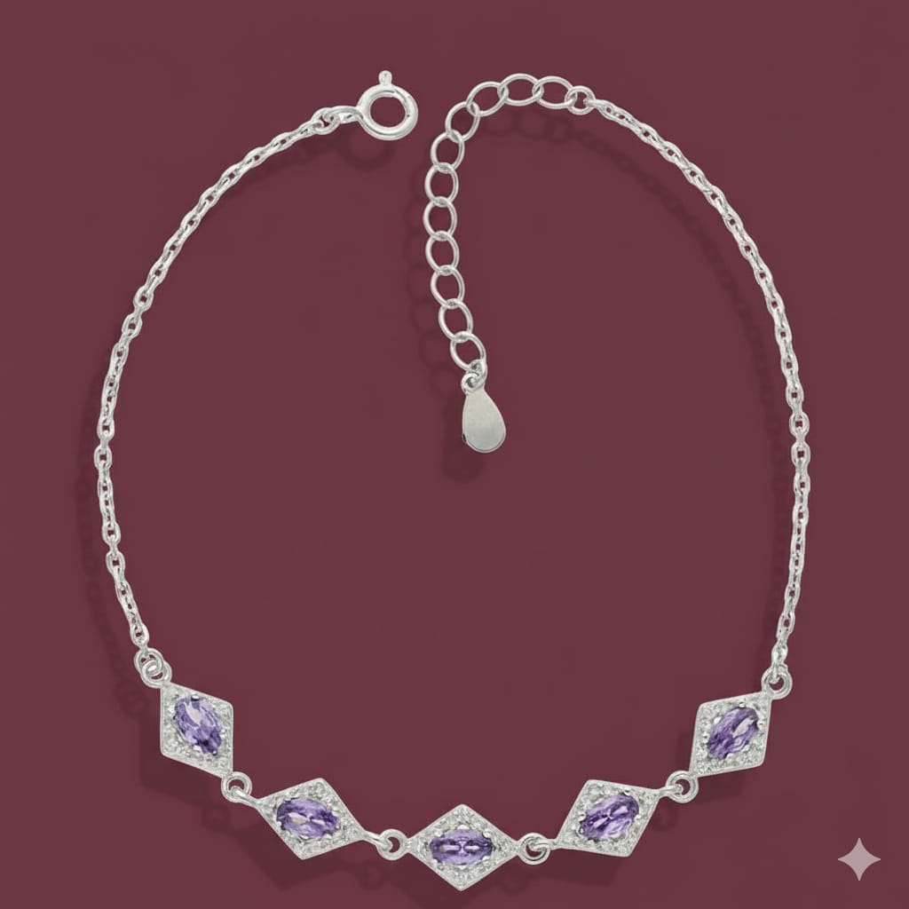 Silver bracelet with purple gemstones on a maroon background
