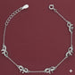 Silver bracelet with elephant charms on a red background