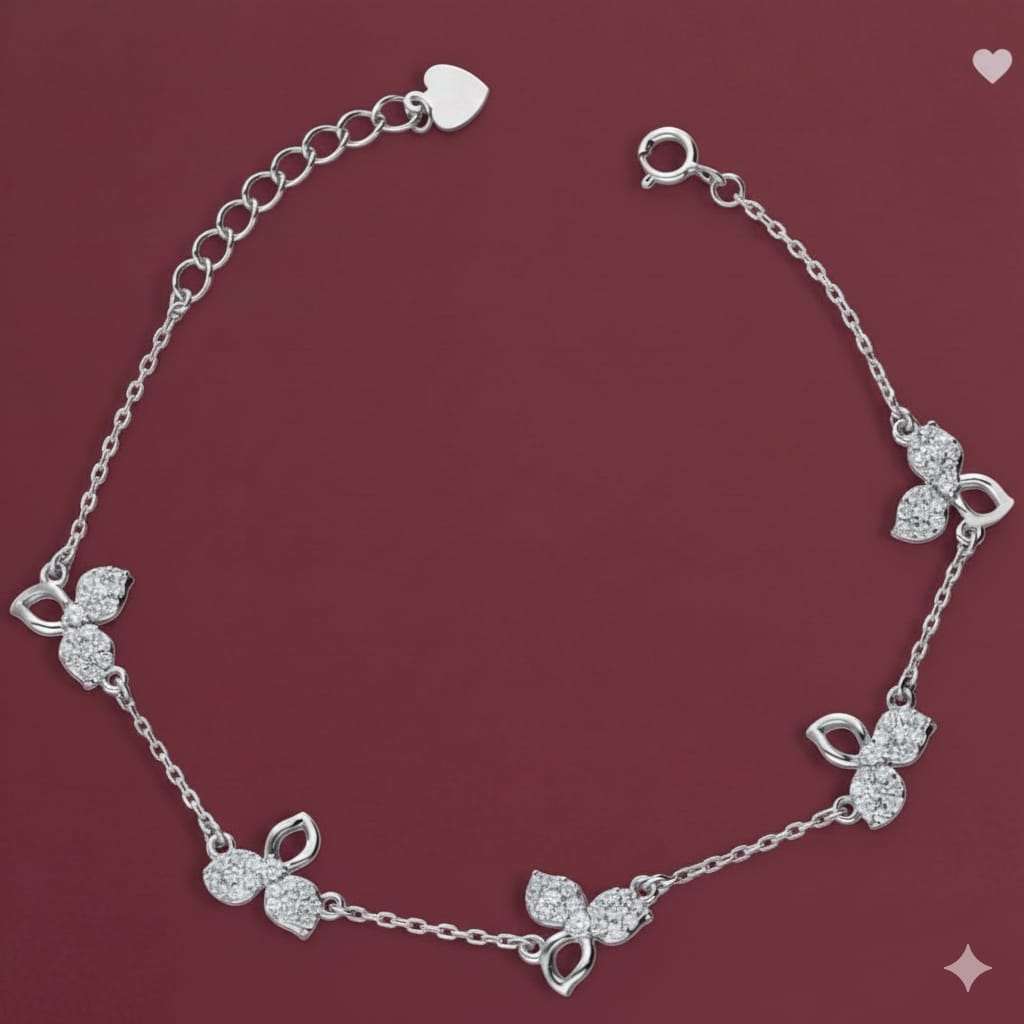 Silver bracelet with floral designs on a red background