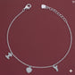 Silver bracelet with charms on a red background