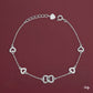 Silver heart-shaped bracelet on a red background