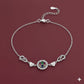 Silver bracelet with a decorative clasp on a red background
