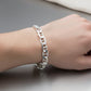 Silver chain bracelet on a red background