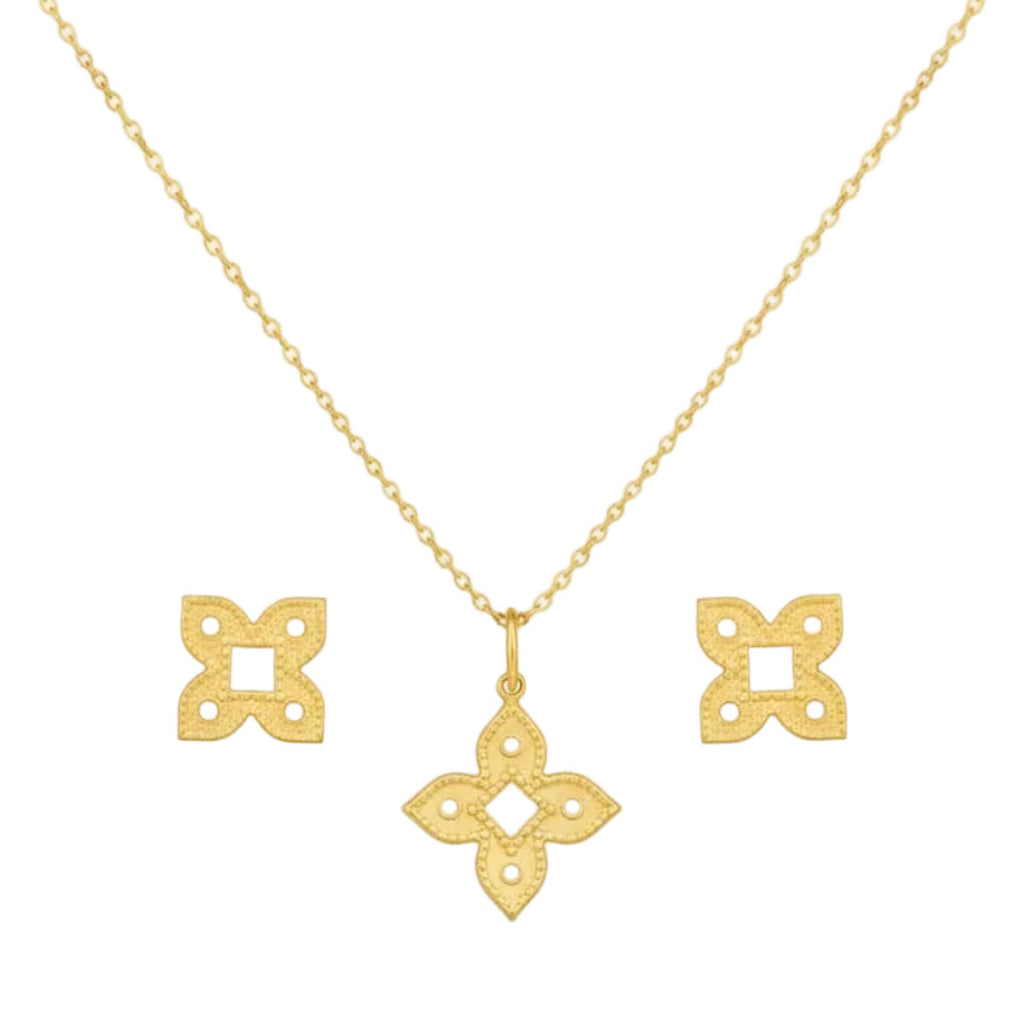 Gold necklace with matching earrings on a white background