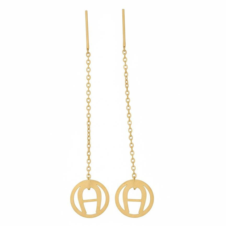 Gold earrings with circular designs on a white background