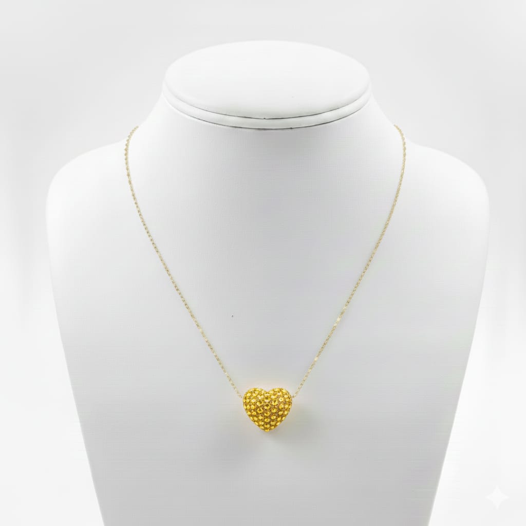 Gold heart-shaped pendant necklace on a mannequin bust against a white background