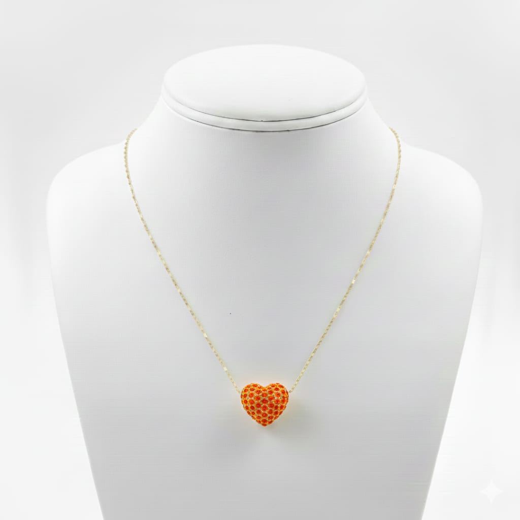 Necklace with a heart-shaped orange pendant on a mannequin bust against a white background
