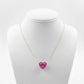 Necklace with a pink heart-shaped pendant on a mannequin bust against a white background
