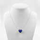 Necklace with a blue heart-shaped pendant on a mannequin bust against a white background