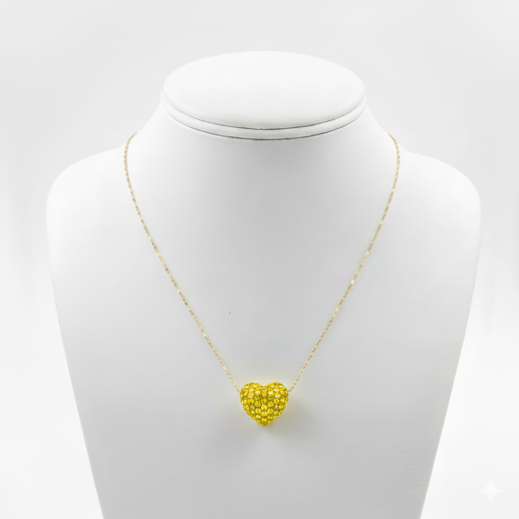 Yellow heart-shaped pendant on a gold chain displayed on a mannequin bust.