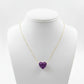 Necklace with a purple heart-shaped pendant on a mannequin bust against a white background