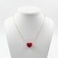 Necklace with a red heart pendant on a mannequin bust against a white background