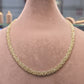 Gold chain necklace on a mannequin with measurements displayed