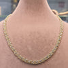 Gold necklace on a mannequin with measurements displayed