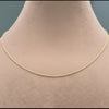 Gold chain necklace on a mannequin with measurements displayed.