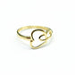 Gold ring with heart design on a gray background