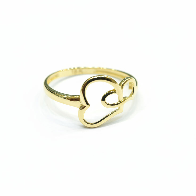 Gold ring with heart design on a gray background