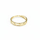 Gold ring with cut-out design on a gray background