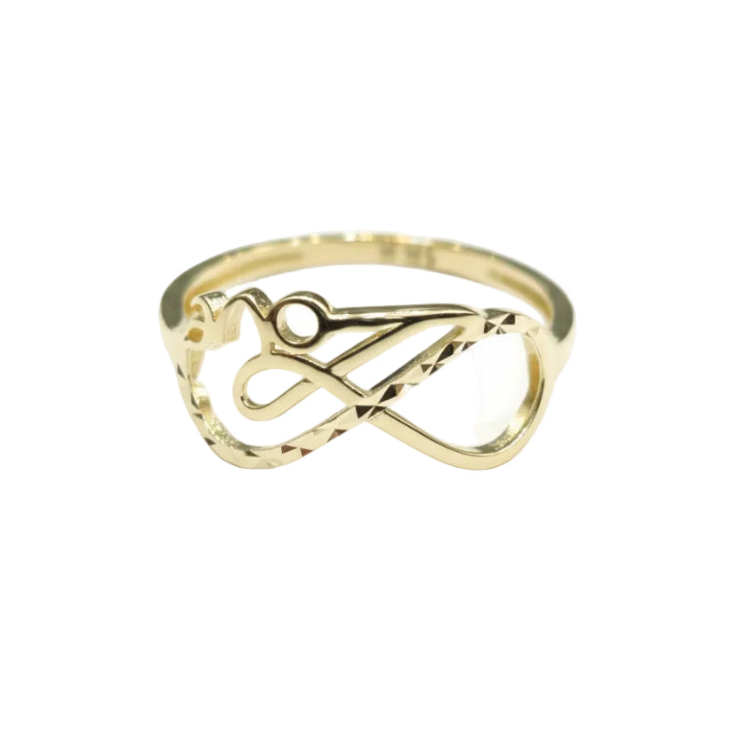 Gold ring with intricate design on a gray background
