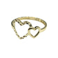 Gold ring with heart design on a gray background