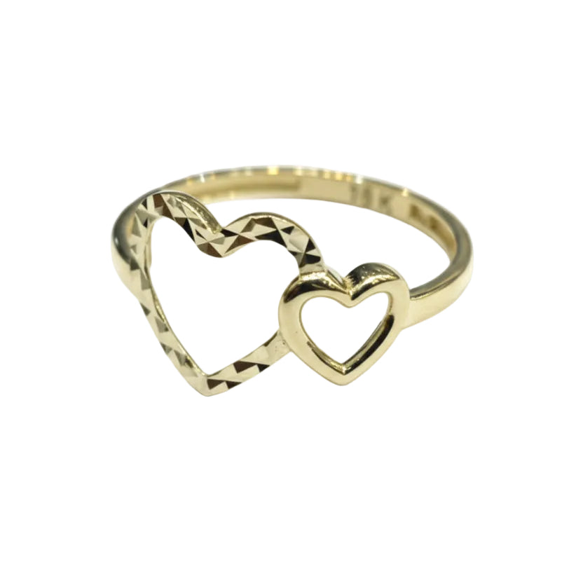 Gold ring with heart design on a gray background