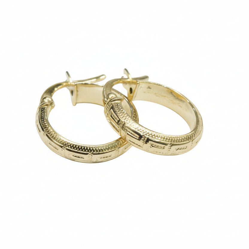 Gold hoop earrings on a white background