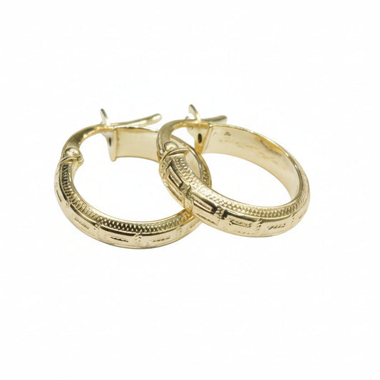 Gold hoop earrings on a white background