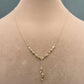 Gold necklace on a mannequin with close-up inset and weight label.