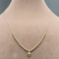 Gold necklace with a heart pendant on a mannequin neck.