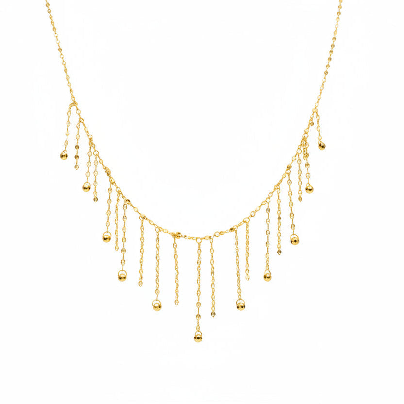 Delicate gold necklace on a mannequin with weight and code information.