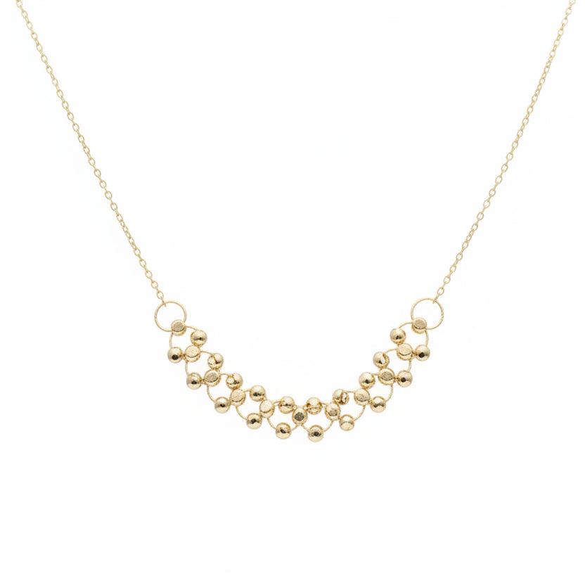 Gold necklace on a mannequin with weight label