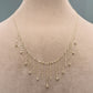 Delicate gold necklace on a mannequin with a neutral background