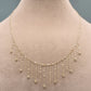 Gold necklace on a mannequin with weight label '1.28g C-14'.