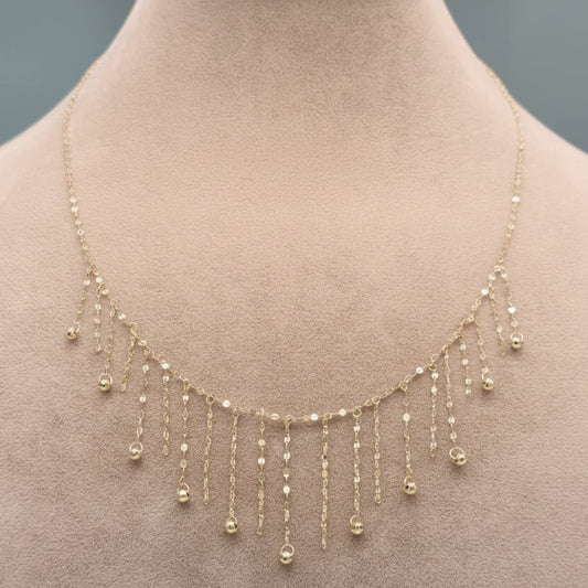 Gold necklace on a mannequin with weight label '1.28g C-14'.