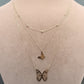 Gold butterfly necklace on a mannequin with weight and code displayed.
