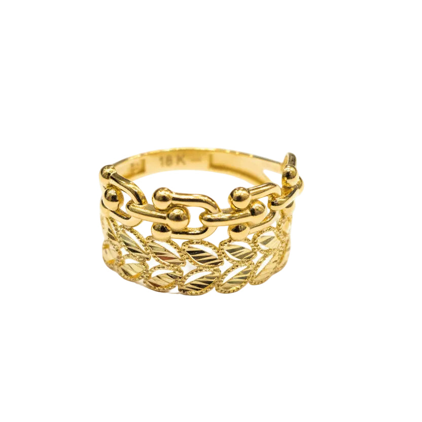 Gold ring with intricate design on a light gray background